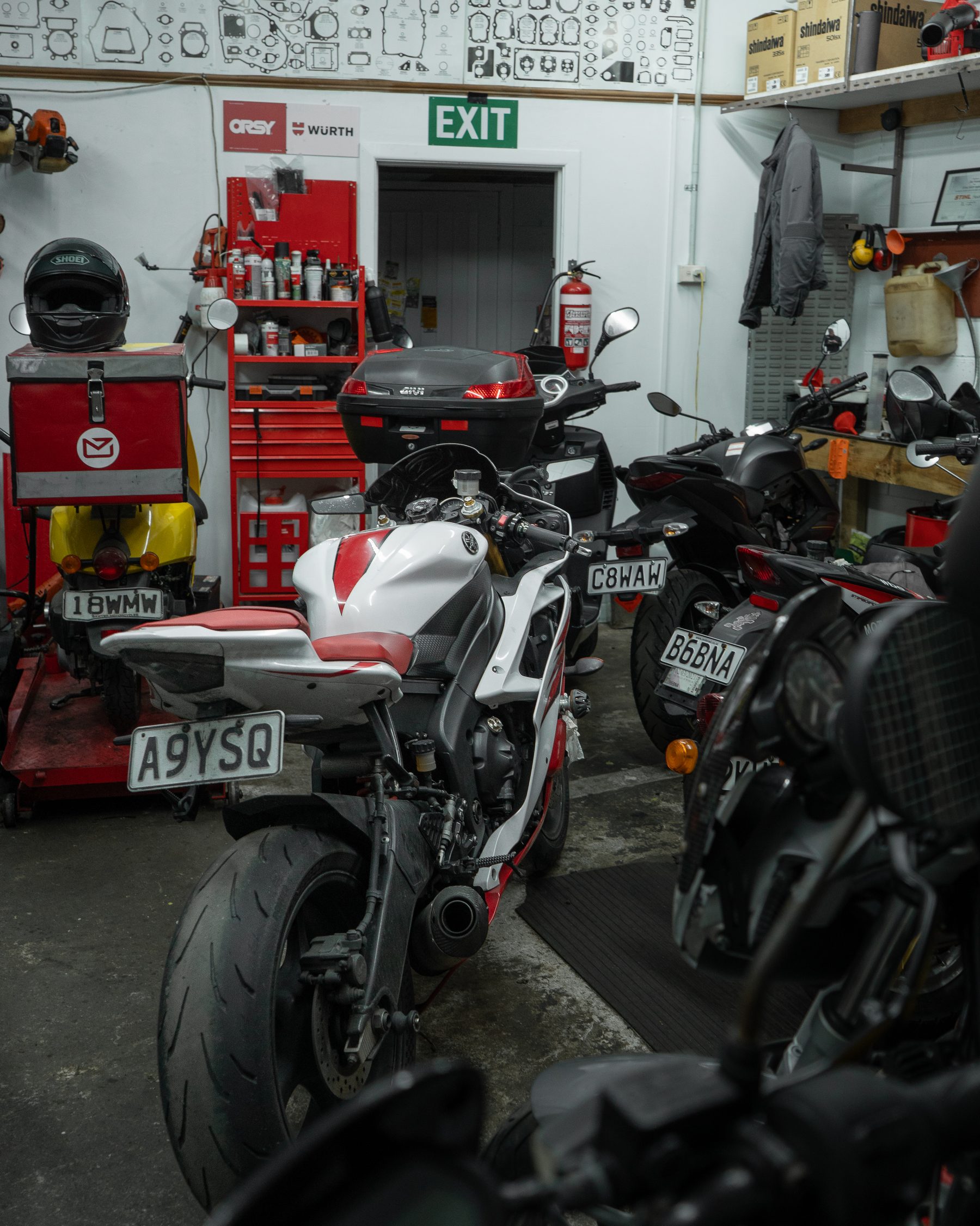 Inside a Wellington motorcycle workshop, bikes lined up mid-service.